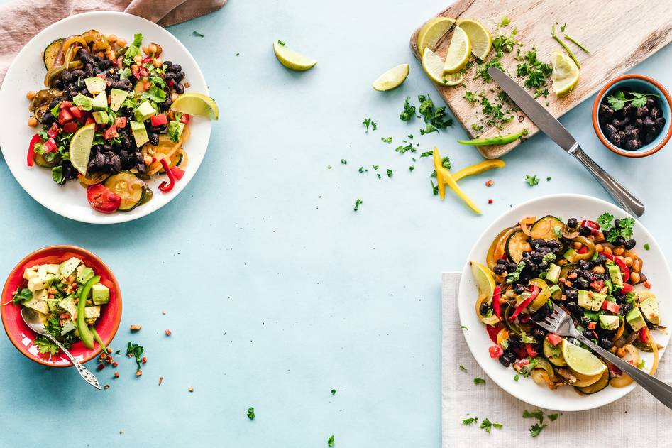 Close-up of handmade ceramic bowls filled with vibrant, colorful organic soups