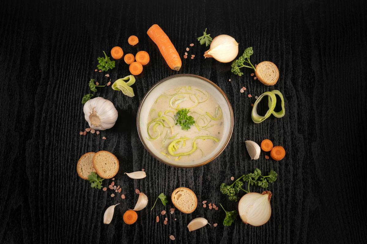 Dairy-Free Recipes featuring a bowl of creamy vegan broccoli soup with cashew base