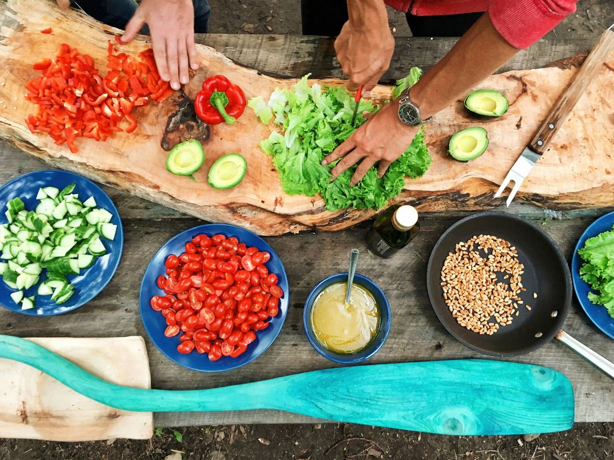 Steaming bowl of vibrant vegetable soup labeled as Meatless Options